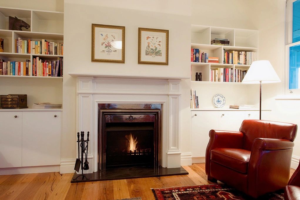 Cozy living room with fireplace and leather armchair.
