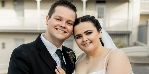 Happy newlyweds Truw and Jamie-Lea Oquendo posing together on their wedding day.