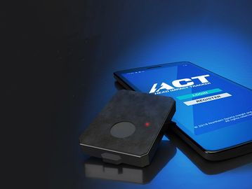 Picture of the ACT Head Impact Sensor next to a cell phone with the ACT-Tracker opened