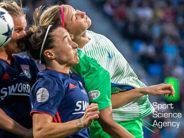 3 female soccer players going for the ball and banging heads 