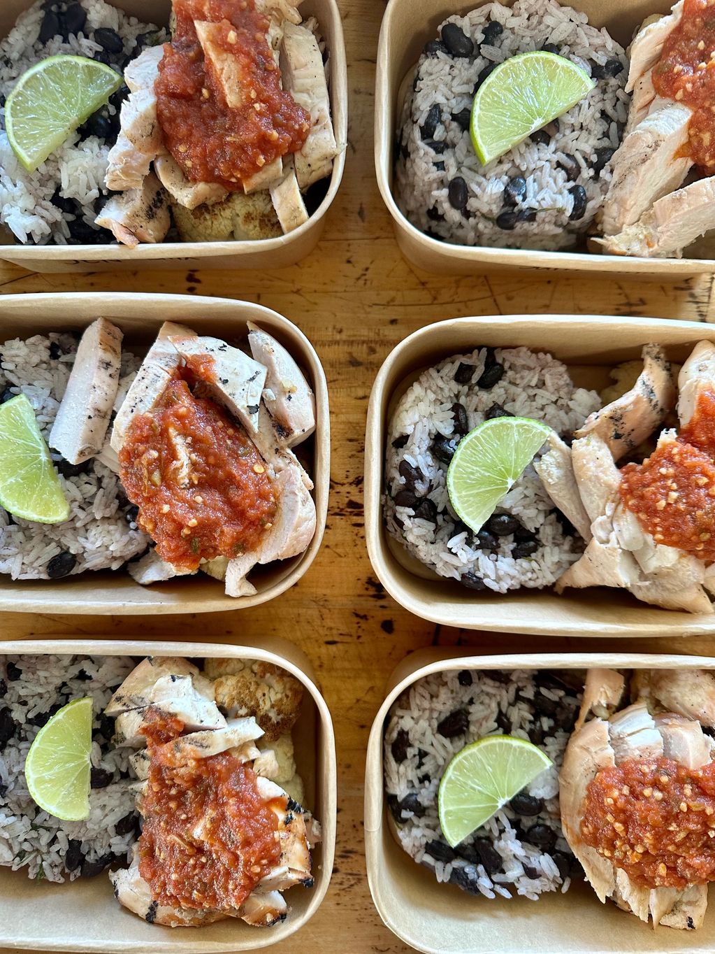 Chicken with salsa, rice and beans lime wedge 