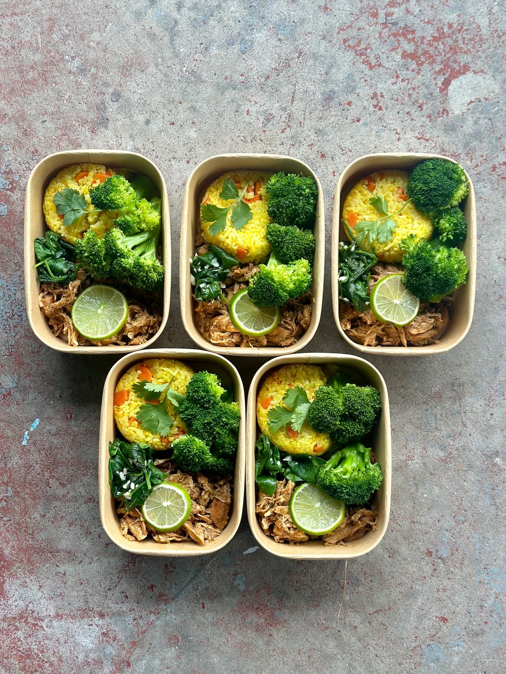 Shredded chicken kale broccoli rice in box meal prep 
