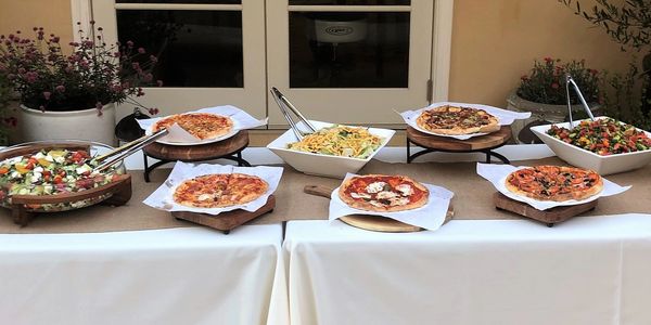 Feast buffet style pizza setting with 2 salads