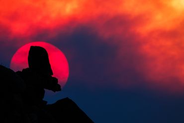 Setting sun, smoke from wildfire, rocky silhouette, summer, Joshua Tree National Park