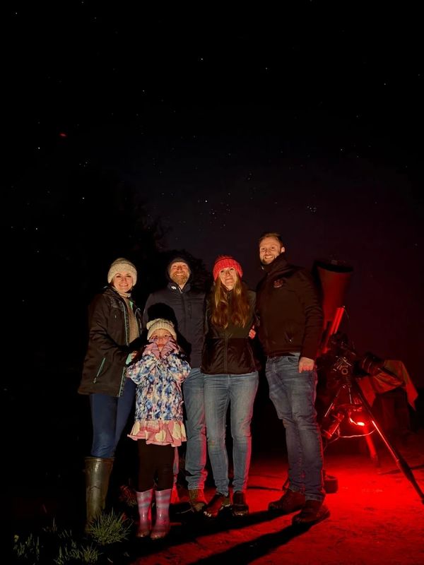A family with a NOVA astronomer Jordan Mansfield on a stargazing experience 