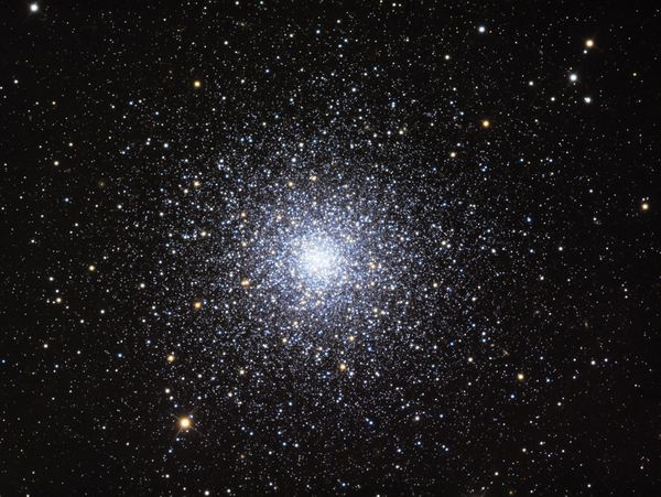 A dense globular cluster filled with countless stars against a black space background.