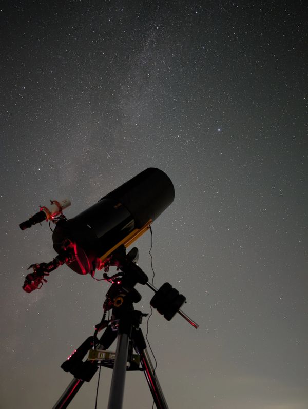 Telescope pointed at a starry night sky in Wiltshire with the Milky Way visible.