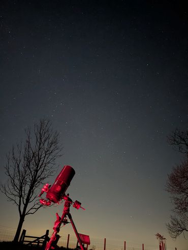 Cepheus and Cassiopeia in the night sky with a telescope in front