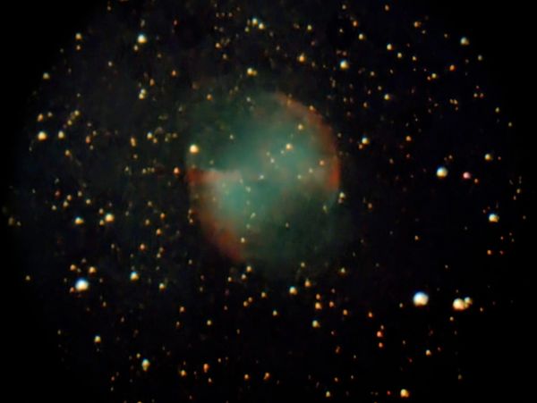 A glowing nebula surrounded by numerous stars in deep space.