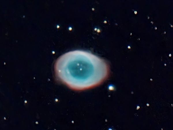 The Eye of God Nebula glowing in deep space.