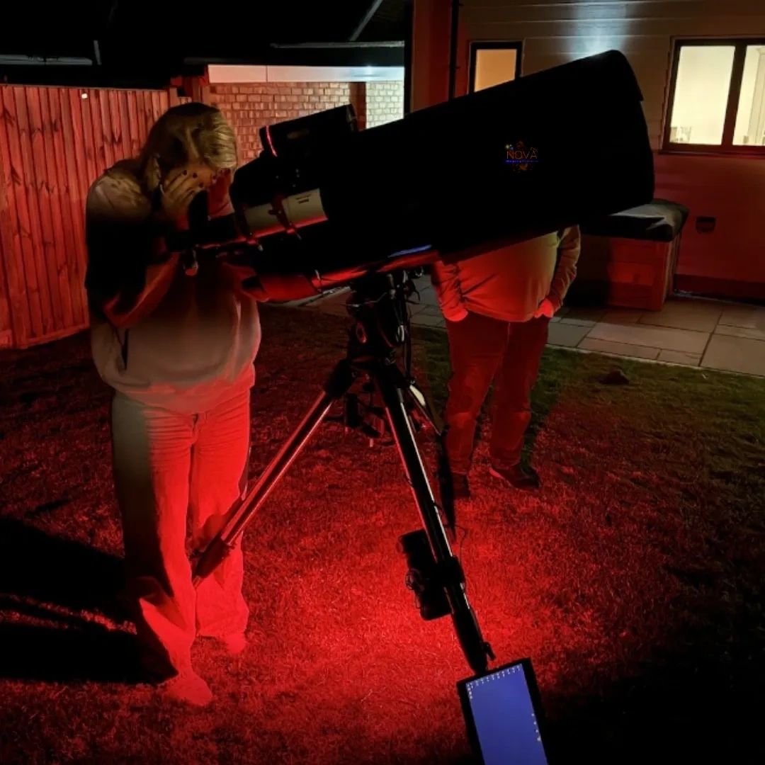 Experience goer using our mobile observatory to explore the night sky
