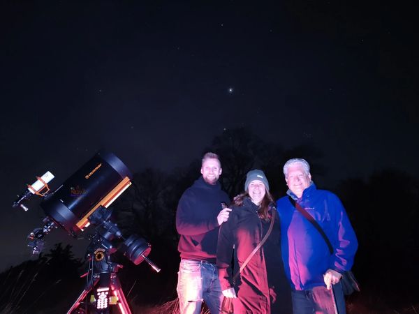 A couple with NOVA's mobile observatory under the night sky in Worcestershire
