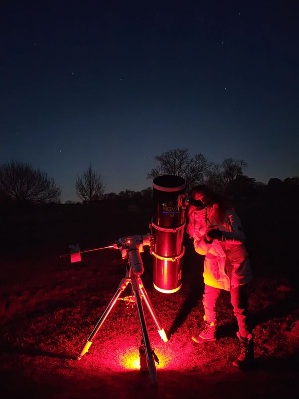 A trainee NOVA astronomer using a telescope 