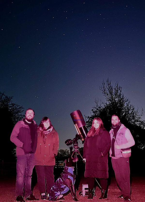 A group of 4 with NOVA's mobile observatory under the night sky in Derbyshire