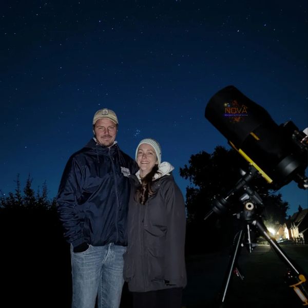 A young couple with NOVA's mobile observatory under the night sky in Worcestershire