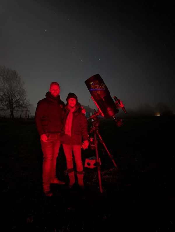 NOVA astronomer Jordan Mansfield with a customer on a stargazing experience 