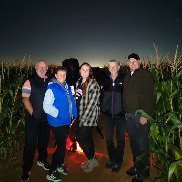 A family on a stargazing experience under the night sky in Shustoke