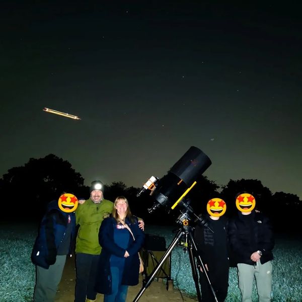 A family of 5 with NOVA's mobile observatory under the night sky in Balsall Common
