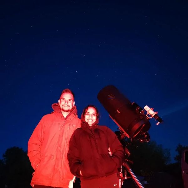 A happy couple smiling under the night sky in Reepham, Norfolk