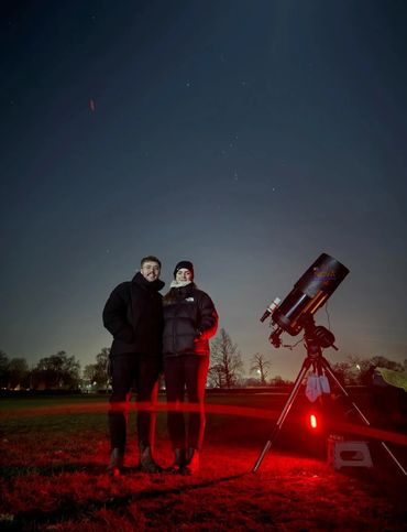 Couple stargazing in Derbyshire with telescope.