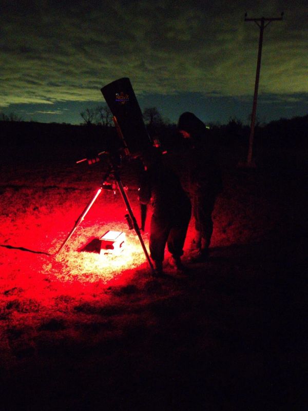 A couple using NOVA's mobile observatory under the night sky in Northamptonshire