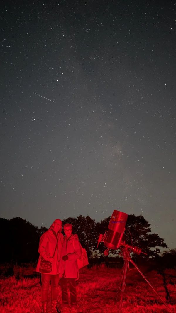 Two friends on a NOVA stargazing experience under the night sky in Balsall Common