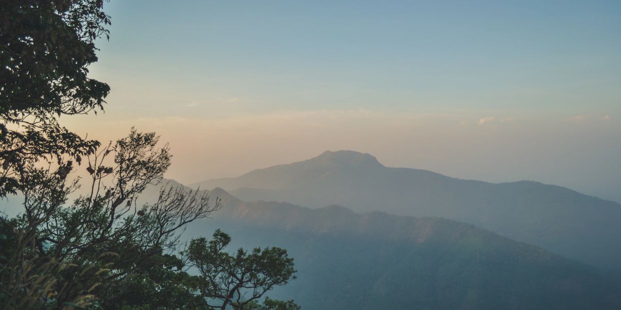 Golden hour sunset over the rolling hills of Vagamon from Mountain Villa’s scenic viewpoint