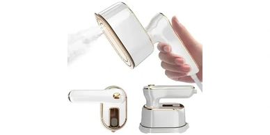 White handheld garment steamer with gold accents releasing steam.
