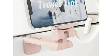 Pink car headrest phone holder displaying travel tips on a smartphone.