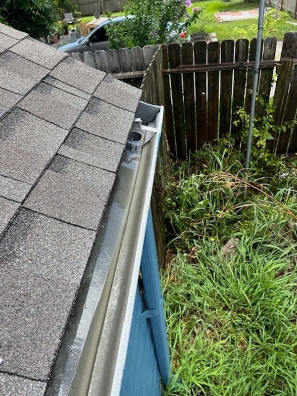 A clean gutter on a blue house 