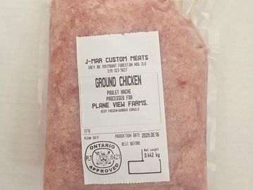 Vacuum-sealed package of ground chicken from J-Mar Custom Meats, Ontario approved.