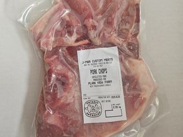 Vacuum-sealed pork chops from J-Mar Custom Meats with an Ontario approval stamp.