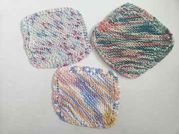 Three colorful hand-knitted dishcloths on a white background.