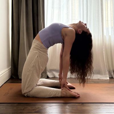 yoga teacher doing camel asana or camel pose