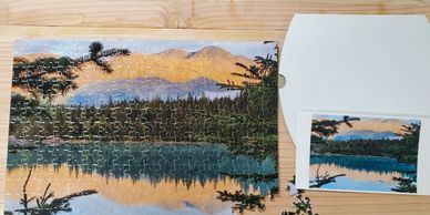 Picture of a mountain lake in Alaska as a 252 piece puzzle. Shown with reference photo and box