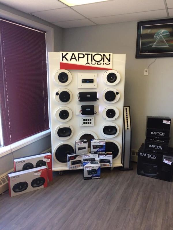 Display of Kaption Audio speakers and audio equipment in a showroom corner.
