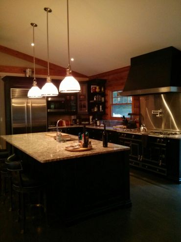 Cozy kitchen with a large island and pendant lights.