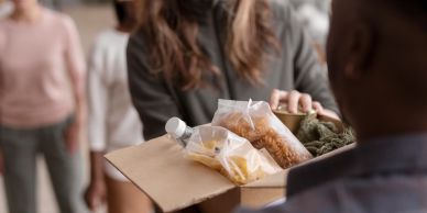 Person receiving a box of food supplies.