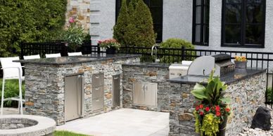 completed L-shaped stone outdoor kitchen