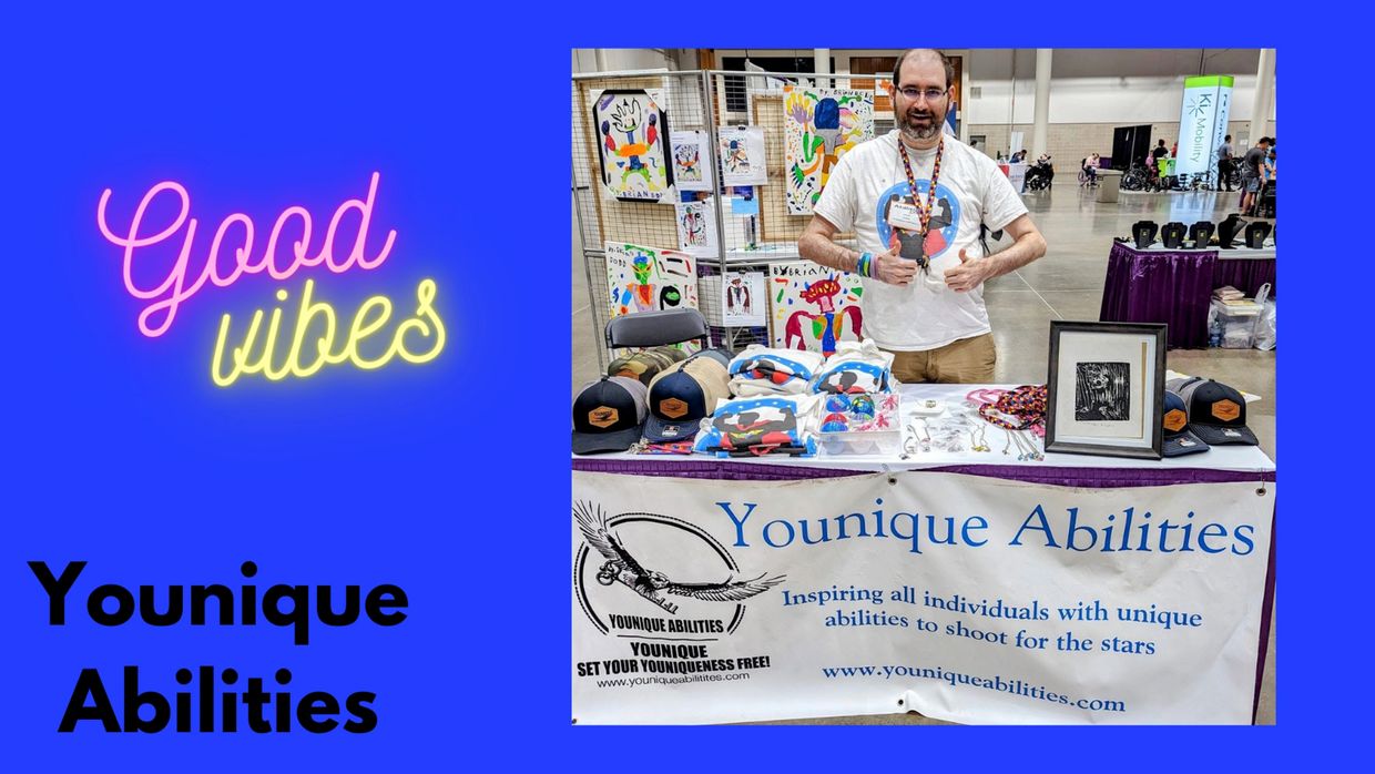 Adam Farris Founder standing in front of his table with handmade autism awareness merchandise