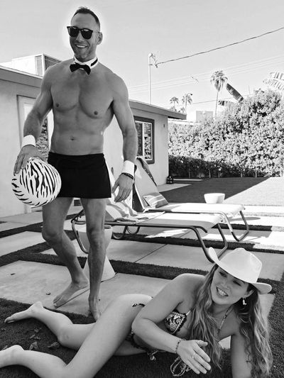 Charming cabana boy in Dallas entertains a fun bachelorette party poolside with games and drinks.