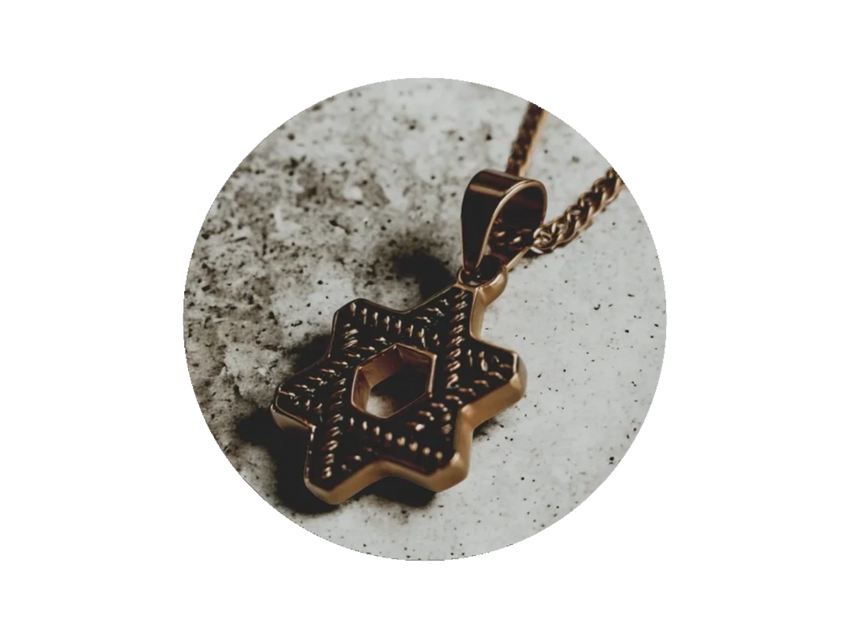 A gold Star of David pendant dangling against a textured cement backdrop.