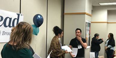 Dare to Lead participants standing and engaging in partner chats about the content