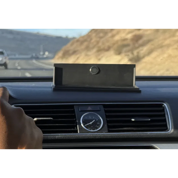 Cell phone holder on a car dashboard while driving