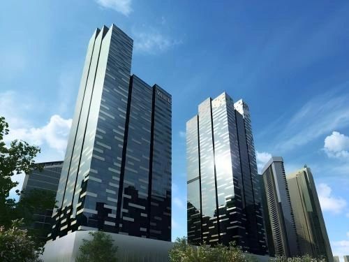 Modern glass skyscrapers reflecting the blue sky in an urban setting.