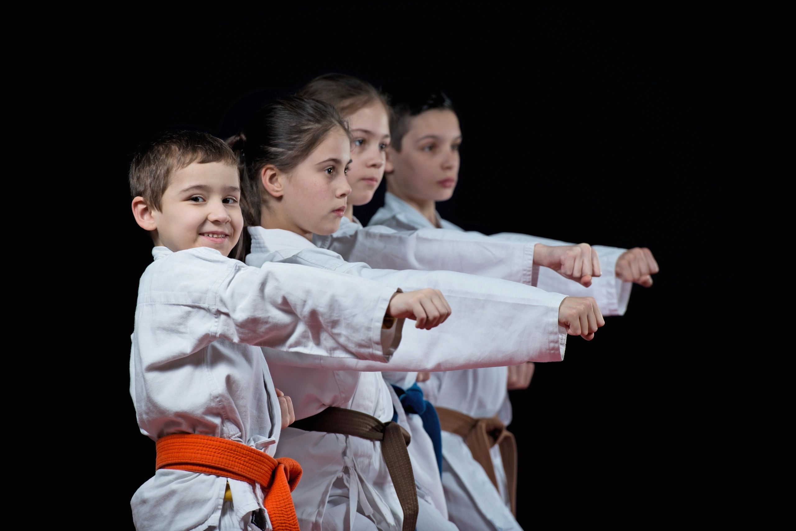 4 kids punching while looking at the camera 