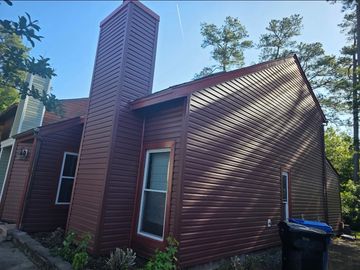 Stylish brown siding that complements the forested exterior. Like ACE Home Improvements