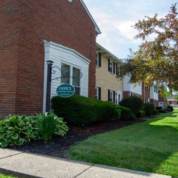 Exterior of an office building in a residential area with well-kept landscaping.