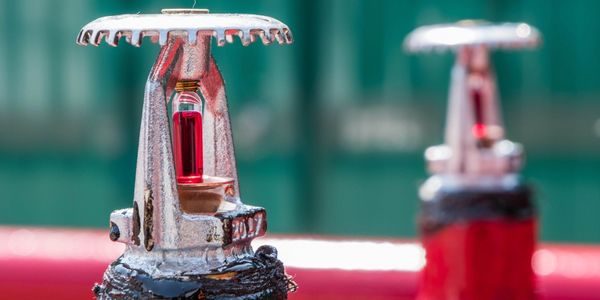 A closeup of a fire sprinkler outside