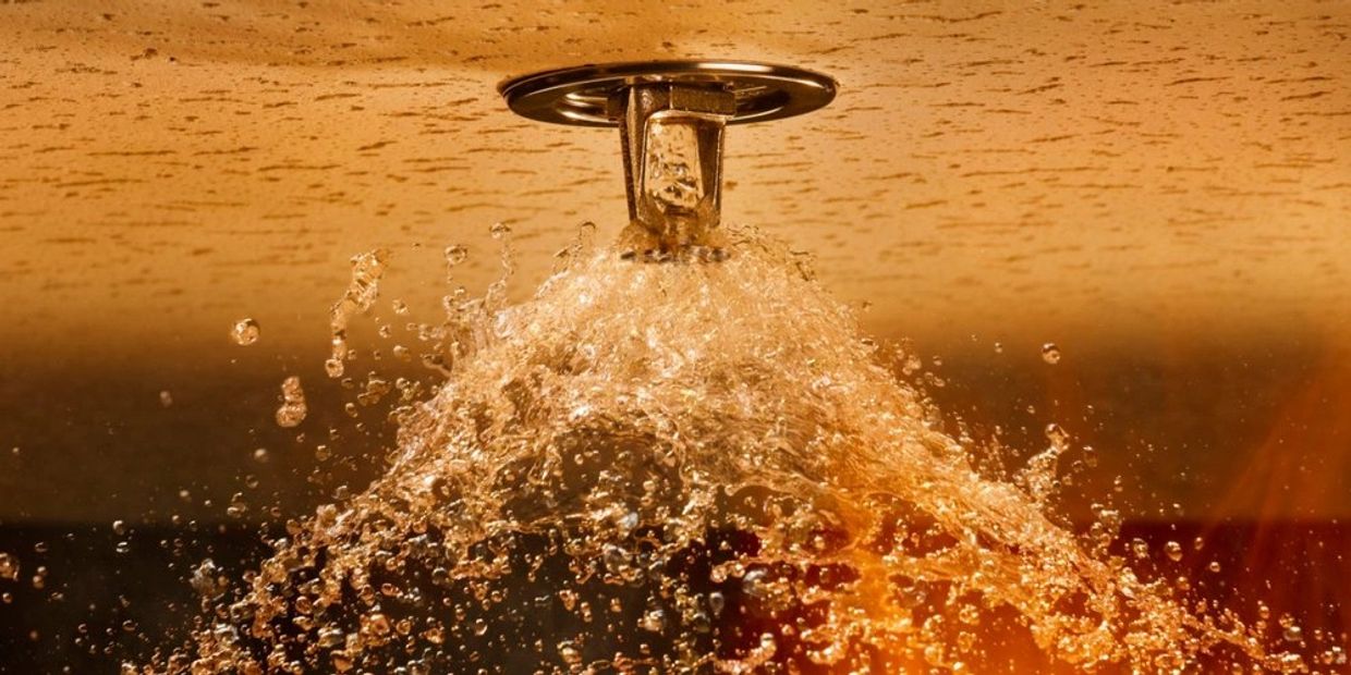 A fire sprinkler extinguishing a fire